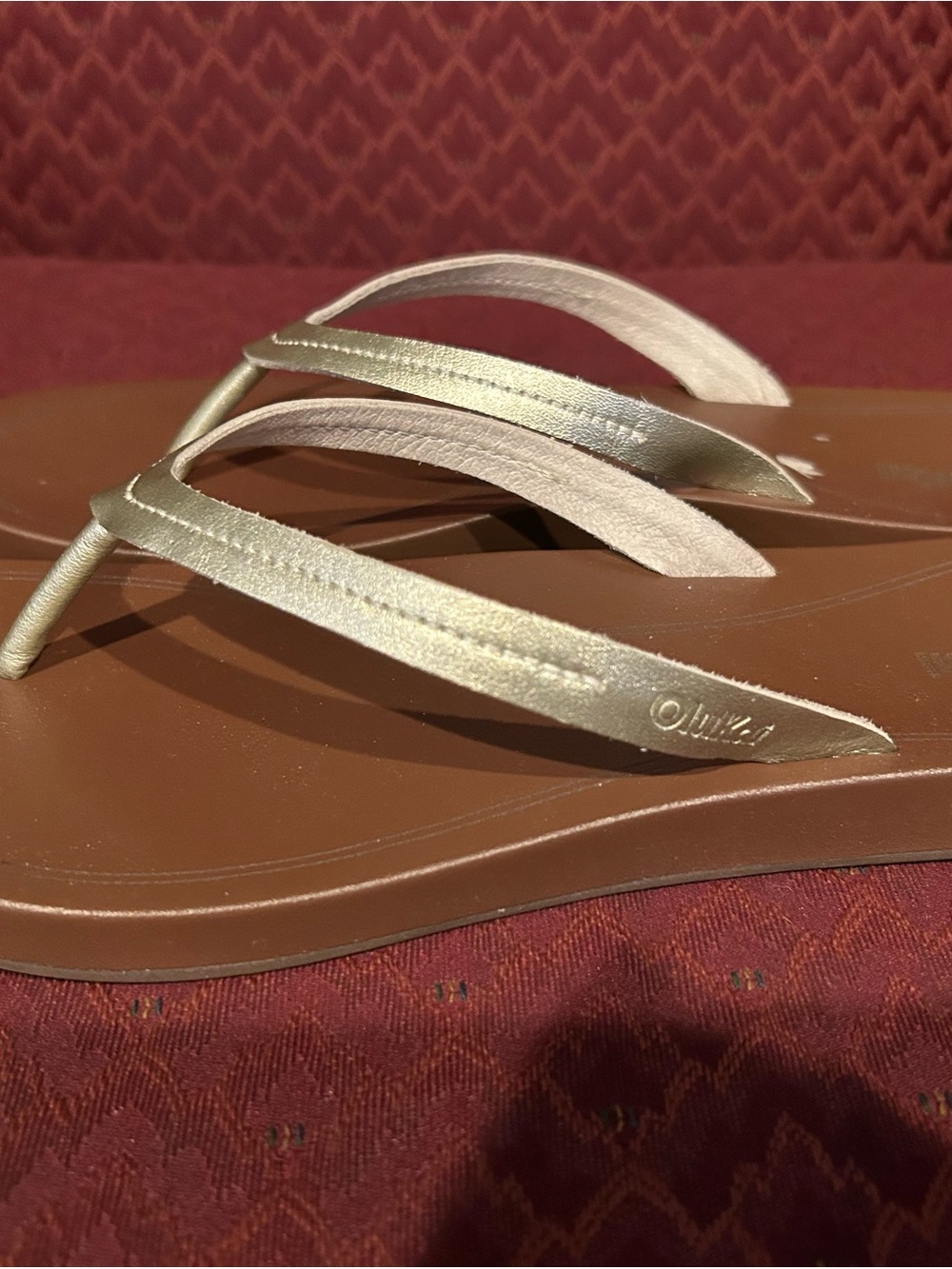 OluKai Women’s Metallic Gold flip flop Sandal with Brown Footbed